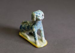 LATE 18th/EARLY 19th CENTURY, POSSIBLY STAFFORDSHIRE EARTHENWARE PRIMATIVE MODEL OF A DOG, seated
