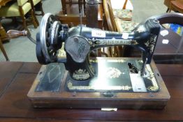 SINGER MANUAL PORTABLE SEWING MACHINE AND A MILESTONE SHAPED WALL MIRROR (2)