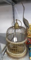 VICTORIAN STYLE SMALL BRASS BIRD CAGE, CIRCULAR AND DOME TOPPED AND MOUNTED WITH THE FIGURE OF A