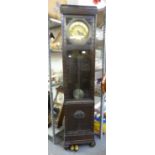 A 1930's CARVED OAK LONGCASE CLOCK, WITH CIRCULAR BRASS DIAL AND GLAZED DOOR