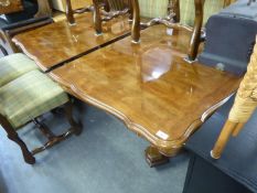 A WALNUTWOOD DINING TABLE WITH TWO LOOSE LEAVES