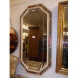 AN OCTAGONAL FLORAL FRAMED WALL MIRROR WITH LEAD DECORATION (103cm x 52cm)