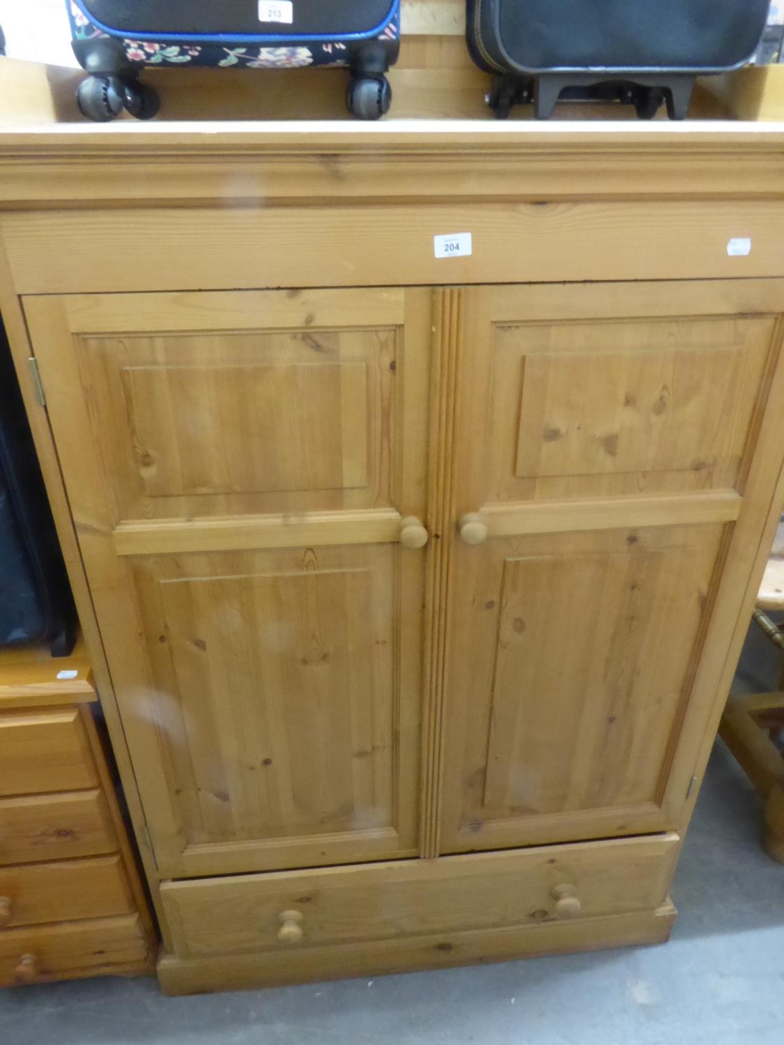 A TWO DOOR AND 1 DRAWER PINE CABINET TALL BOY