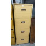 A LIGHT OAK FINISH 4 DRAWER FILING CABINET WITH CUP HANDLES