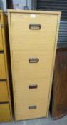 A LIGHT OAK FINISH 4 DRAWER FILING CABINET WITH CUP HANDLES