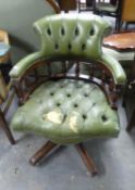 A CAPTAIN'S CHAIR, COVERED IN GREEN LEATHER (WORN AND TORN) ON A FIVE SPUR BASE