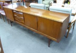 A MID-CENTURY TEAK LONG, LOW SIDEBOARD, damage to the top left corner of the bottom drawer