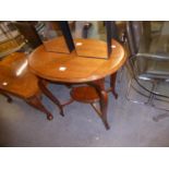 LATE VICTORIAN WALNUT OCCASIONAL TABLE with oval top and moulded cabriole legs tied by a
