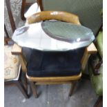 A FRAMELESS BEVELLED EDGE OVAL WALL MIRROR AND A TUB SHAPED ARMCHAIR (2)