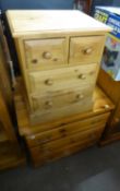 A SMALL PINE CHEST OF THREE LONG DRAWERS, 2’6” AND A PINE BEDSIDE CHEST OF TWO SHORT AND TWO LONG