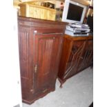 A CARVED OAK ANTIQUE CORNER CUPBOARD