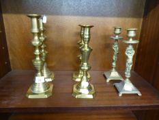 PAIR OF EARLY 20th CENTURY CAST BRASS FEMALE FIGURAL CANDLESTICKS ON SQUARE BASES WITH CORNER