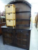 PRIORY DUTCH STYE DOMED TOP DRESSER, THE BASE HAVING TWO DRAWERS OVER TWO CUPBOARDS, WIHT OPEN PLATE