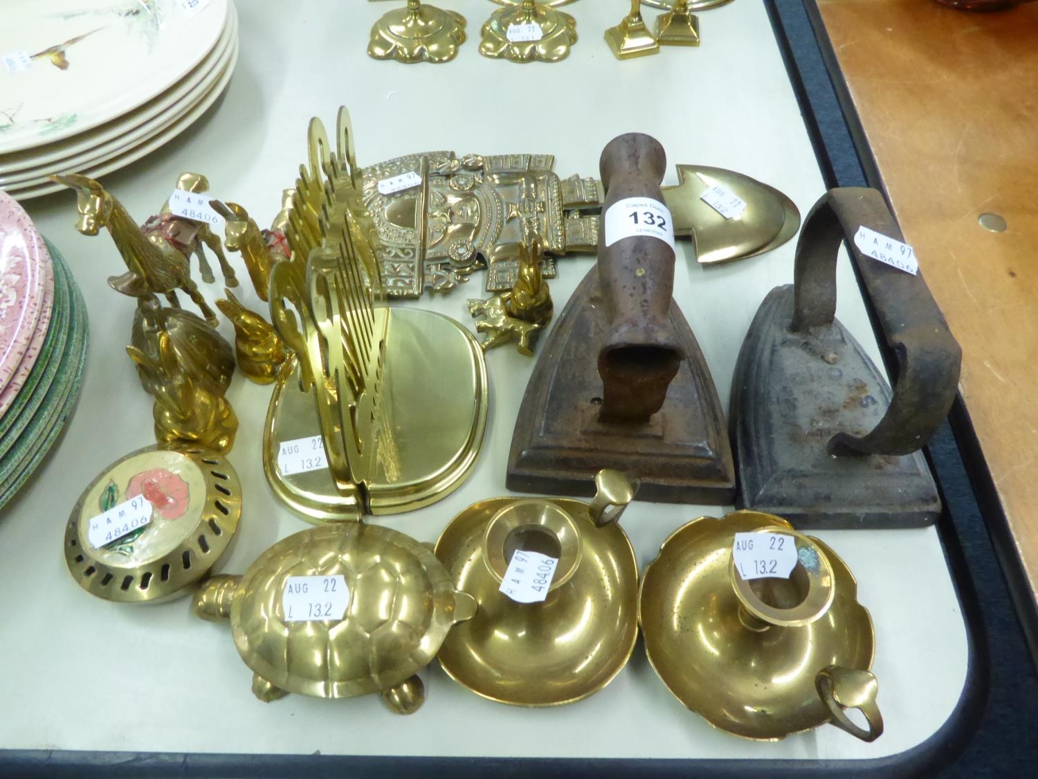 TEN SMALL BRASS ORNAMENTS; TWO CHAMBER CANDLESTICKS, TWO FLAT IRONS, ETC. (APPROXIMATELY 18 PIECES)