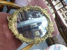 OVAL WALL MIRROR, IN GILT ROCOCO CAST FRAME AND A BEECH WOOD SMALL OPEN ARM EASY CHAIR, IN