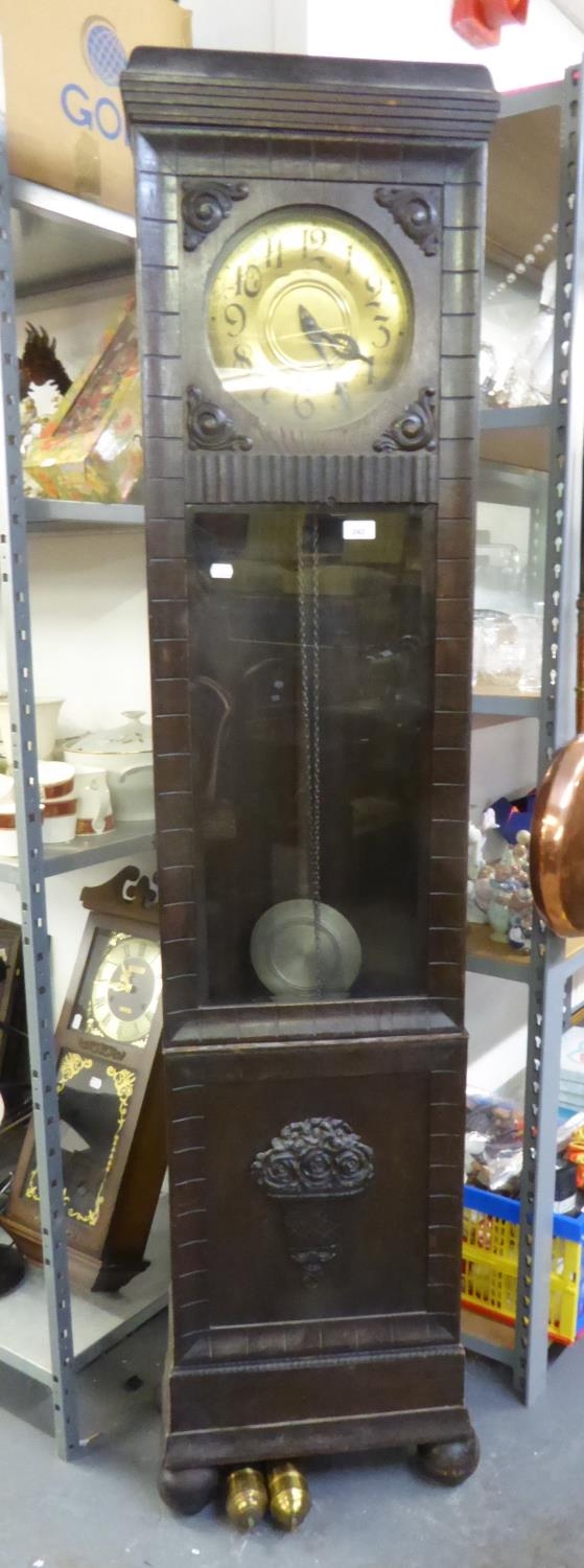 A 1930's CARVED OAK LONGCASE CLOCK, WITH CIRCULAR BRASS DIAL AND GLAZED DOOR