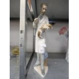 LLADRO FIGURE OF A VET HOLDING A SMALL DOG, 13 1/2in (34.2cm) high