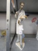 LLADRO FIGURE OF A VET HOLDING A SMALL DOG, 13 1/2in (34.2cm) high