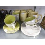 KEITH MURRAY FOR WEDGWOOD, SET OF SIX PALE YELLOW GLAZED POTTERY TANKARDS, AND A NINETEEN PIECE
