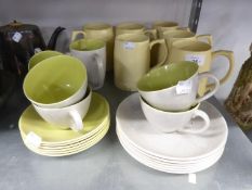 KEITH MURRAY FOR WEDGWOOD, SET OF SIX PALE YELLOW GLAZED POTTERY TANKARDS, AND A NINETEEN PIECE