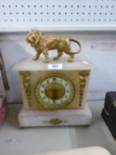 CIRCA 1900 FRENCH ALABASTER AND GILT METAL MOUNTED MANTEL CLOCK SURMOUNTED BY A LION, (glass damaged