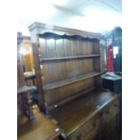 CARVED OAK WELSH DRESSER, (188cm high, 122cm wide) AND AN OAK REFECTORY DINING TABLE (168 x 84cm) (