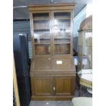 MEDIUM OAK BUREAU BOOKCASE, THE UPPER PORTION ENCLOSED BY TWO GLAZED DOORS, THE BUREAU WITH