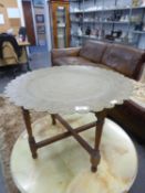EASTERN ENGRAVED BRASS CIRCULAR COFFEE TABLE TOP, ON WOODEN FOLDING STAND