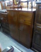 A GENT’S CIRCA 1960'S MAHOGANY SMALL COMPACT WARDROBE, PART OF TOP HINGED TO REVEAL MIRROR AND