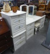 A WHITE ENAMELLED FINISH BEDROOM SUITE COMPRISING, A DOUBLE PEDESTAL DRESSING TABLE, WITH LOOSE