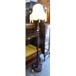 A MAHOGANY BALUSTER TURNED AND SPIRALLY TWISTED STANDARD LAMP, ON CIRCULAR PLATFORM BASE