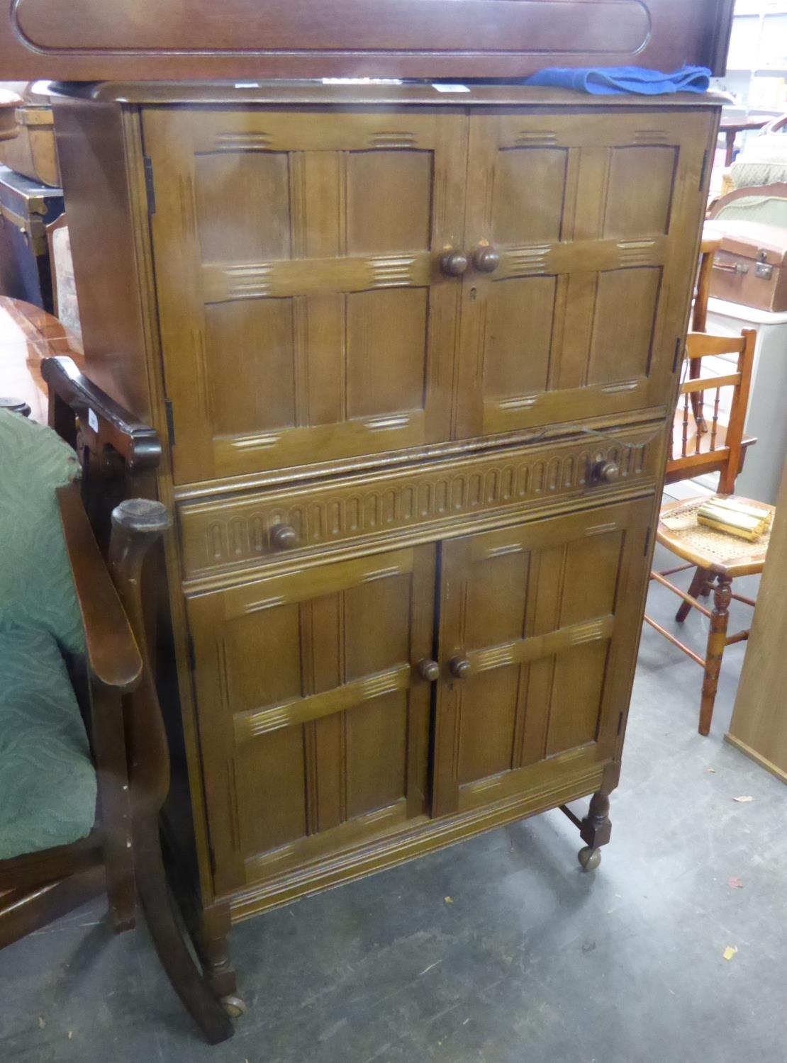 CIRCA 1960S CARVED LIGHT OAK COCKTAIL CABINET WITH FOUR PANE PATTERN DOORS AND MID-SECTION FULL-