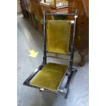 LATE 19TH CENTURY EBONISED WOOD FOLDING COACHING CHAIR, WITH BRASS NAILED GREEN PLUSH PADDED BACK