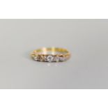 GOLD COLOURED METAL RING, set with five old cut diamonds graduating from the centre, 2.6gms,