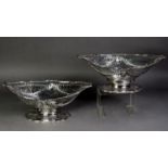 PAIR OF GEORGE III CRESTED AND PIERCED SILVER PEDESTAL FRUIT BASKETS, PROBABLY BY NAPHTHALI HART,