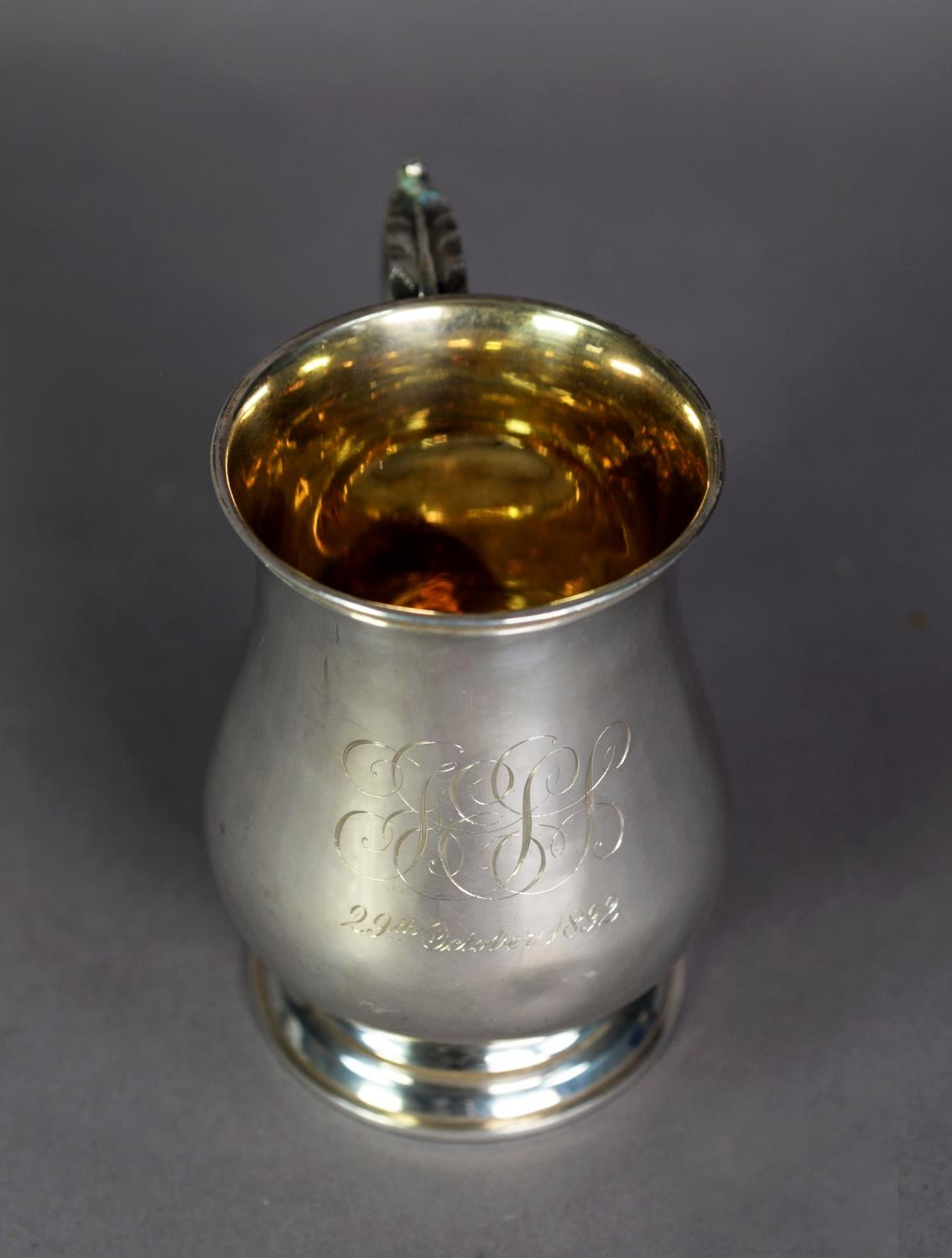 MID-VICTORIAN SILVER BALUSTER SHAPE MUG with gilded interior and leaf-capped scroll handle, later