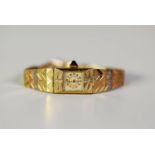 LADY'S 14K GOLD BRACELET WATCH, with mechanical movement, small square silvered dial with gold