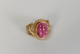 9ct GOLD DRESS RING collect set with a cabochon oval amethyst, pierced scroll shoulders, 7.4 gms,