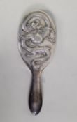 CHINESE EMBOSSED SILVER COLOURED METAL CLAD LADY’S HAND MIRROR, of typical form with oval, bevel
