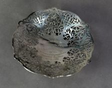 PRESENTATION PIERCED SILVER DISH, of shallow, shaped circular form with foliate scroll pierced