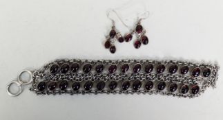SILVER TRIPLE ROW CHAIN BRACELET with two rows each of 14 cup set cabochon oval dark red stones, 8in