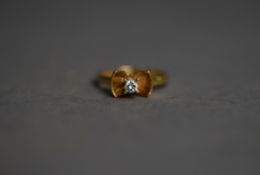 18ct GOLD RING, the bow shape having a round brilliant cut solitaire diamond in a high claw setting,