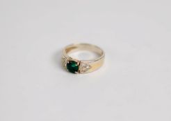 14ct GOLD RING with centre round dark green emerald, the shoulder each with a triangular setting