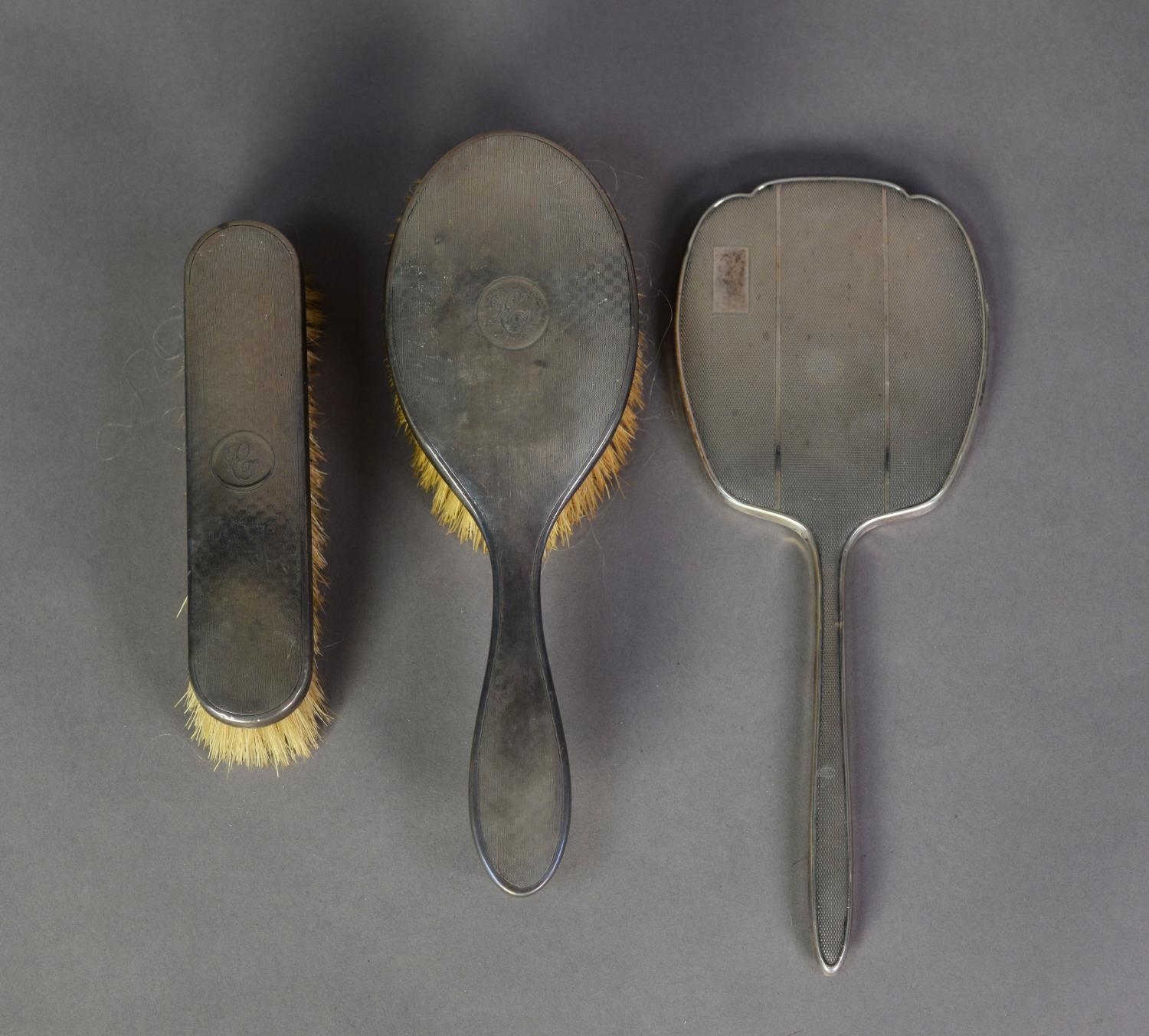 MATCHED THREE PIECE ENGINE TURNED SILVER BACKED DRESSING TABLE HAND MIRROR AND BRUSH SET, the - Image 2 of 2