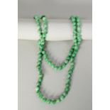 SINGLE STRAND LONG CONTINUOUS NECKLACE OF PALE GREEN JADE UNIFORM ROUND BEADS, approximately 108