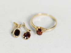 9ct GOLD RING with an oval garnet in a four claw setting and a pair of MATCHING PIN EARRINGS (no