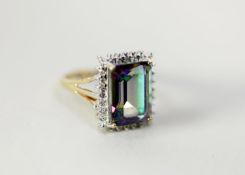 9ct GOLD DRESS RING set with a rectangular mystic topaz, the deceptive setting set with two tiny