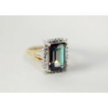 9ct GOLD DRESS RING set with a rectangular mystic topaz, the deceptive setting set with two tiny