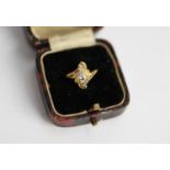 18ct GOLD SCROLLED CROSS-OVER RING set with 7 small round brilliant cut diamonds, 3.4 gms, ring size