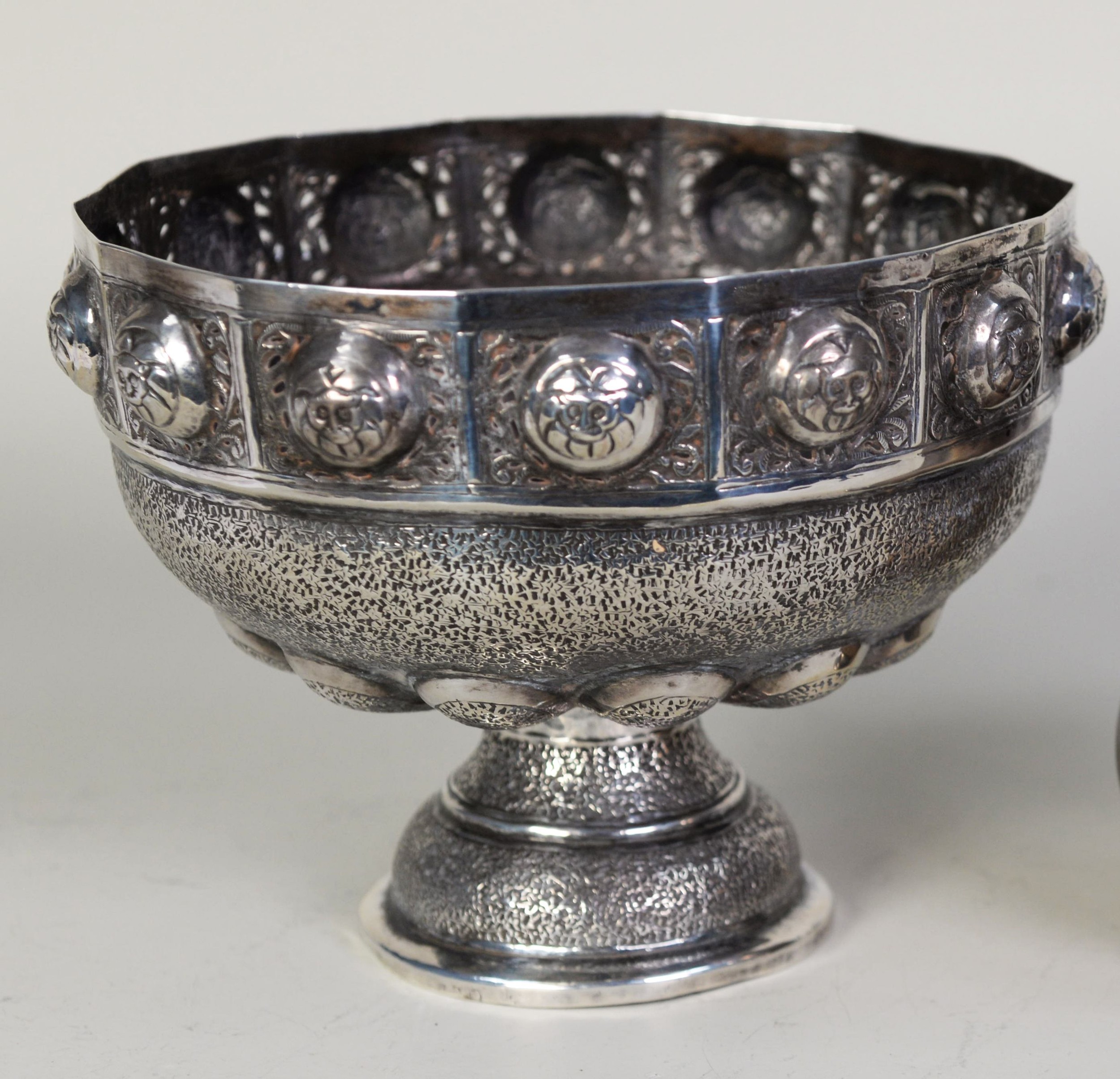 PROBABLY NEAR EASTERN UNMARKED SILVER COLOURED METAL PEDESTAL BOWL, of semi lobated form, embossed